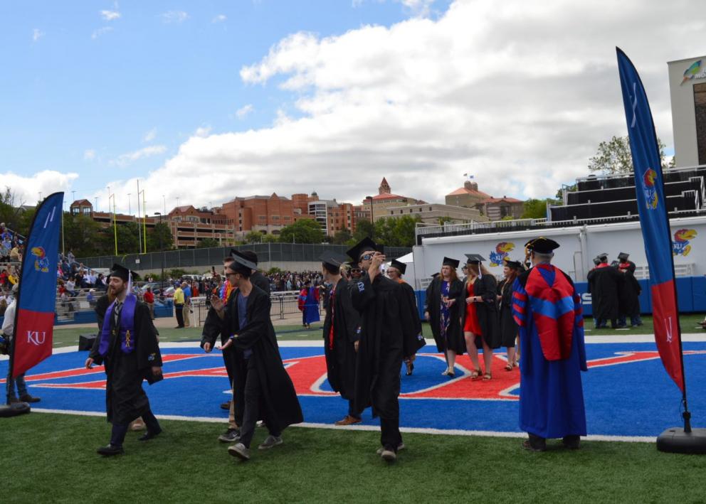 Graduates walking on the field